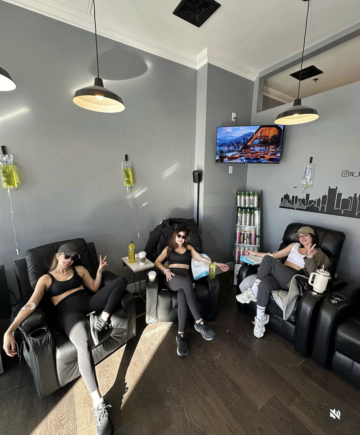 Group of friends getting IV therapy together in the bright South Boston hydration lounge